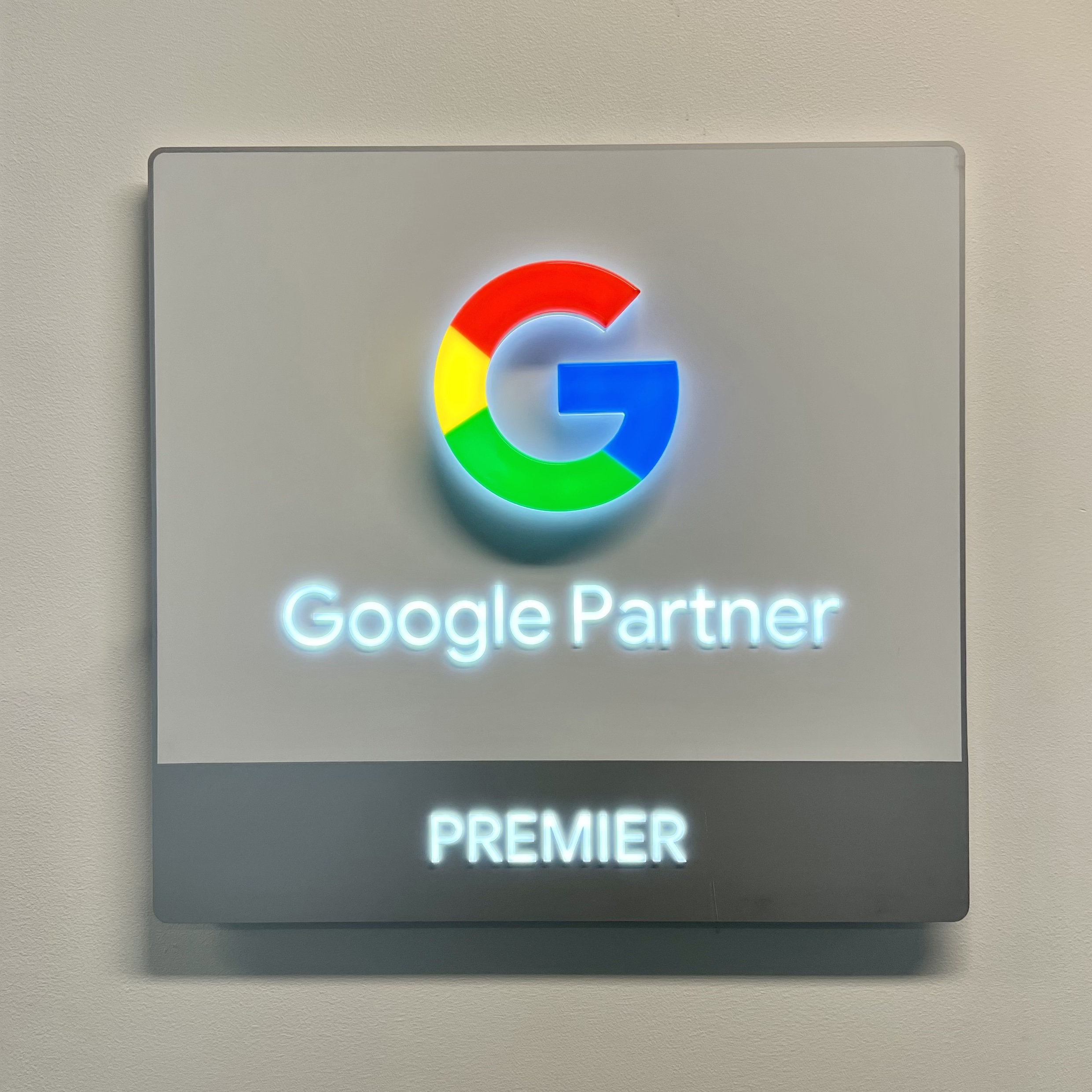 Google Premier Partner badge mounted on the wall.